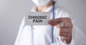 Physician holding chronic pain sign
