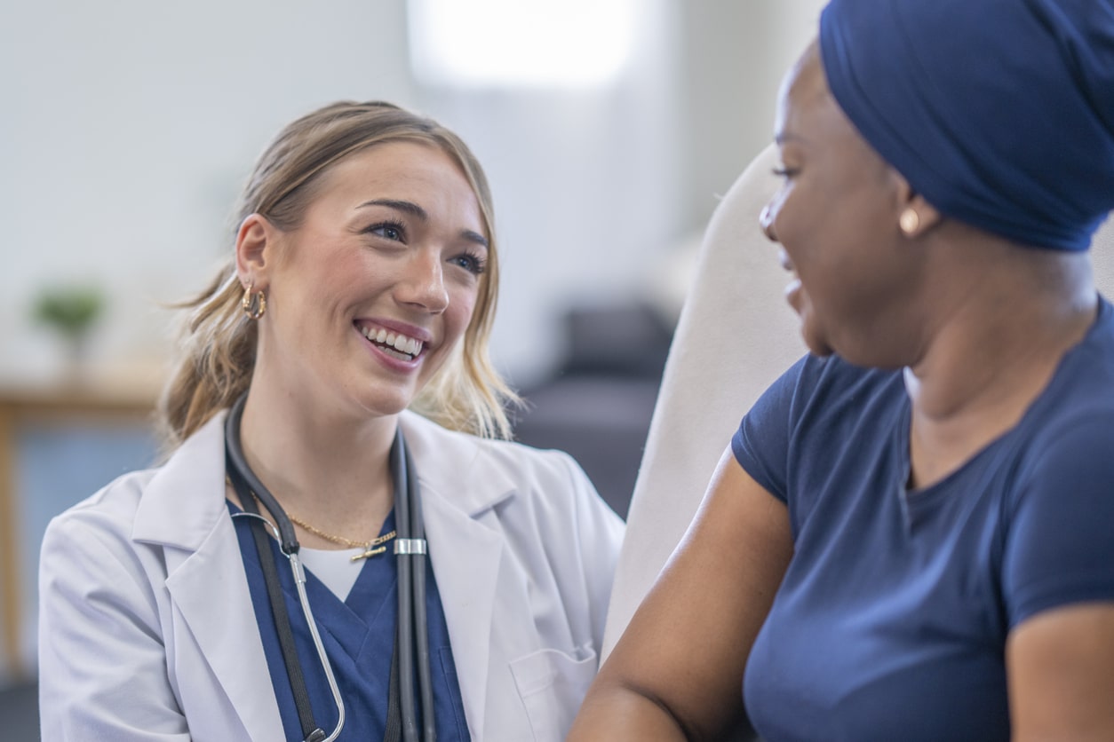 female doctor smiles at female patient who is pain free