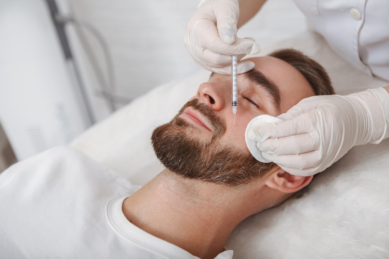 doctor's office giving a man dermal fillers in his face