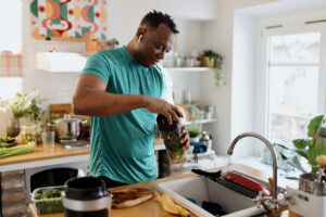 A man making a post workout healthy shake to manage metabolic syndrome