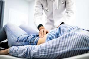 Gastroenterologist conducting abdominal examination of a patient